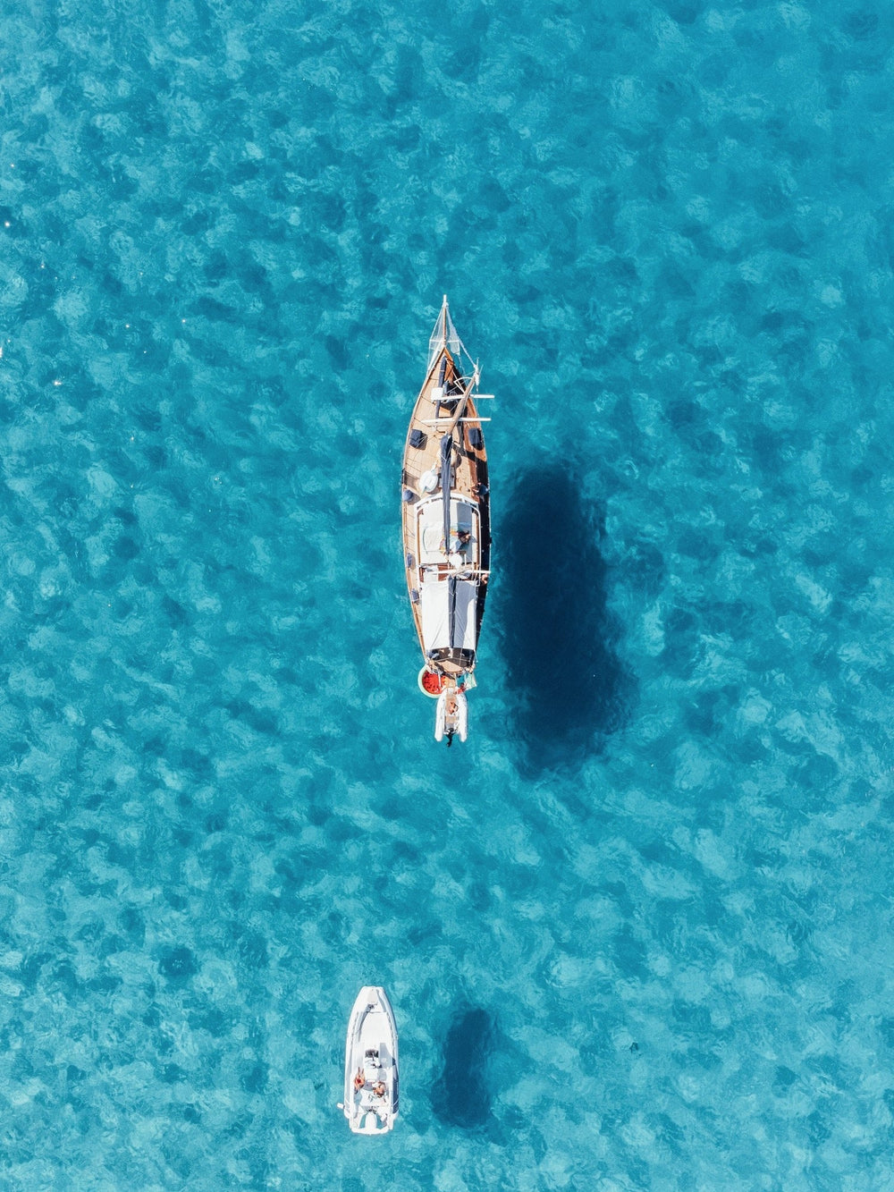 A sailboat on the Caicos Banks from above