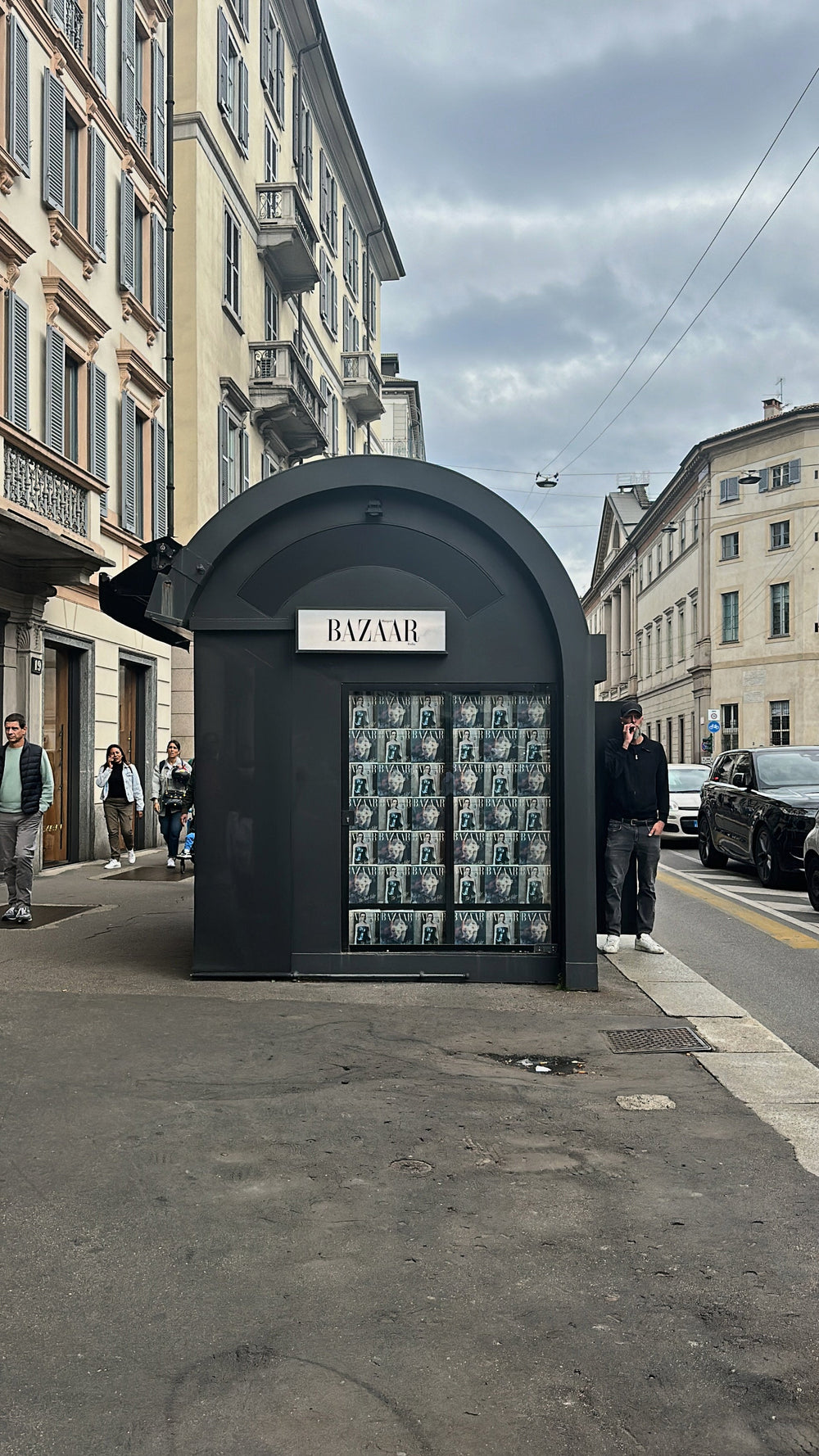 A black newsstand lined with Harper's Bazaar Italia covers, Milan
