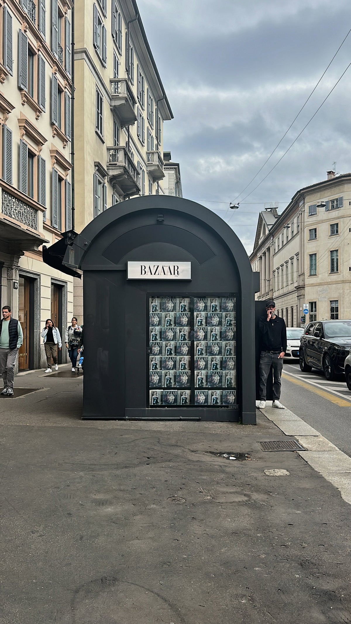 A black newsstand lined with Harper's Bazaar Italia covers, Milan