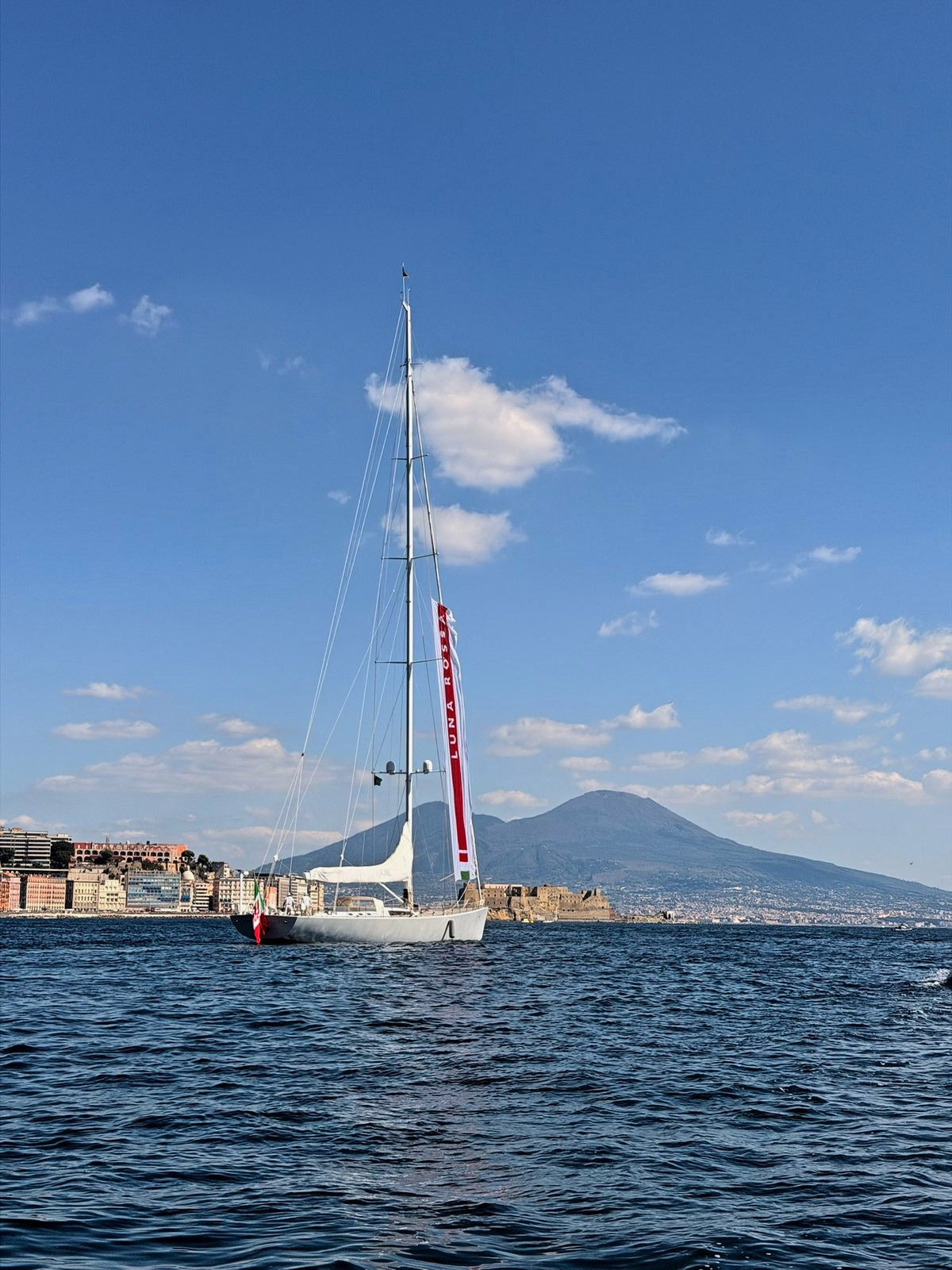 A sailboat on the Bay of Naples with Vesuvius beyond